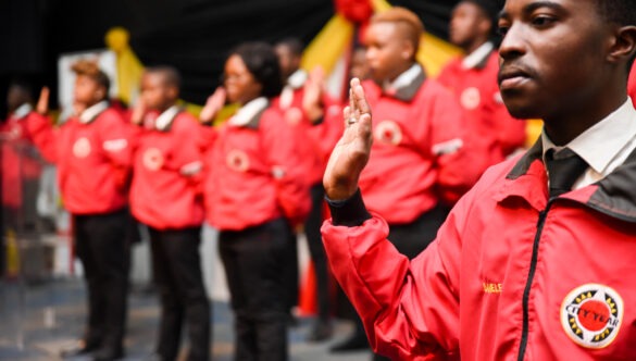 Service leaders in red jackets onstage taking the City Year pledge