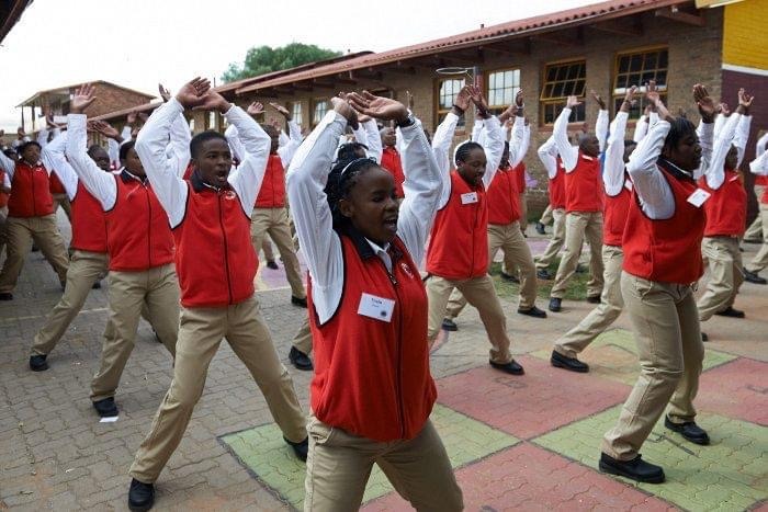 City Year South Africa service leaders doing jumping jacks during PT (physical training)