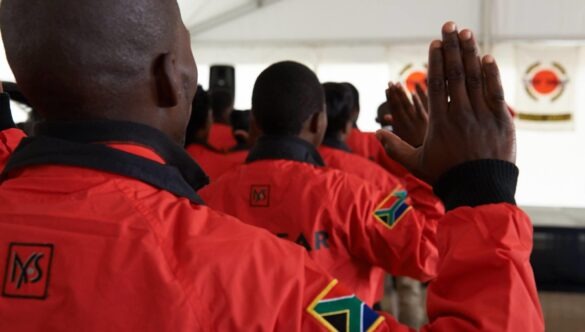 City Year South Africa service leaders in red jackets with hands up for the pledge